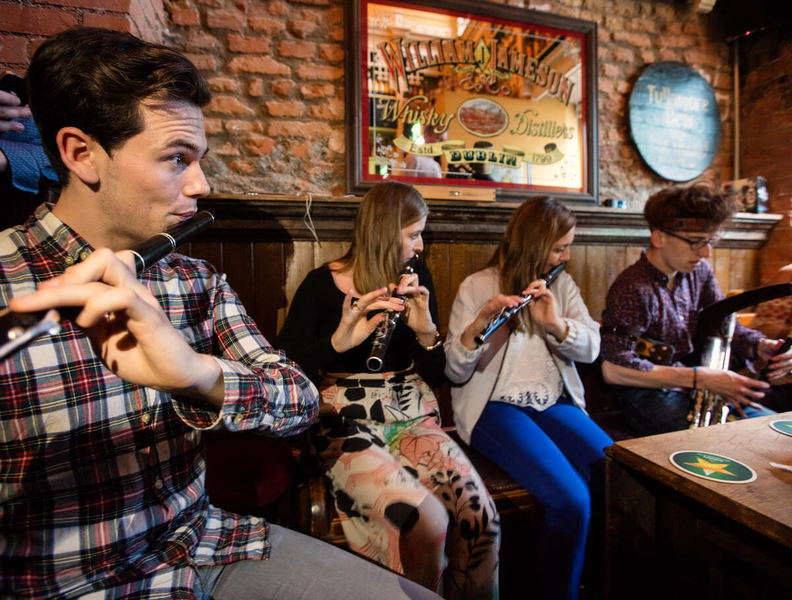 Four musicians playing inside a bar.